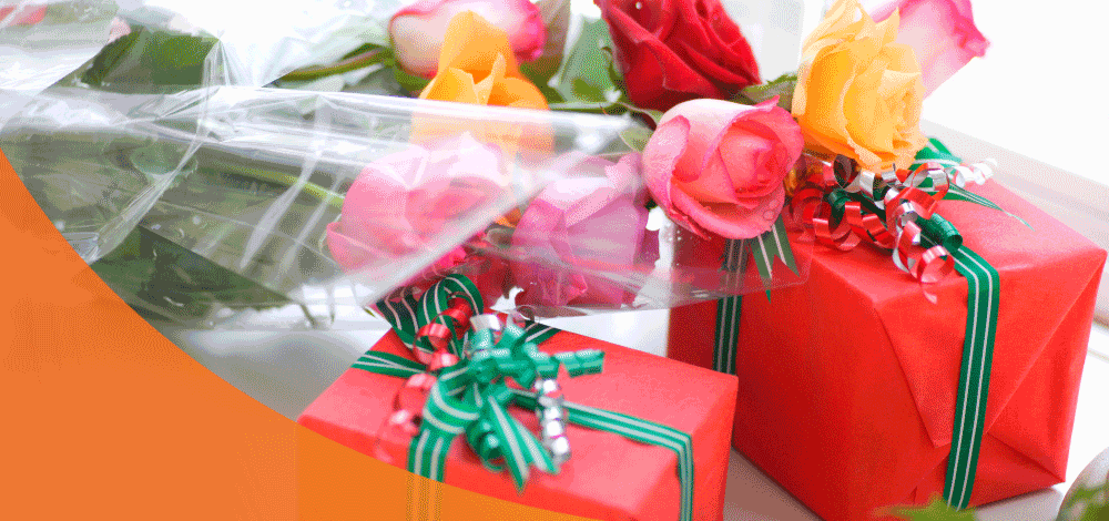 Bunch of colorful flowers and two holiday gifts